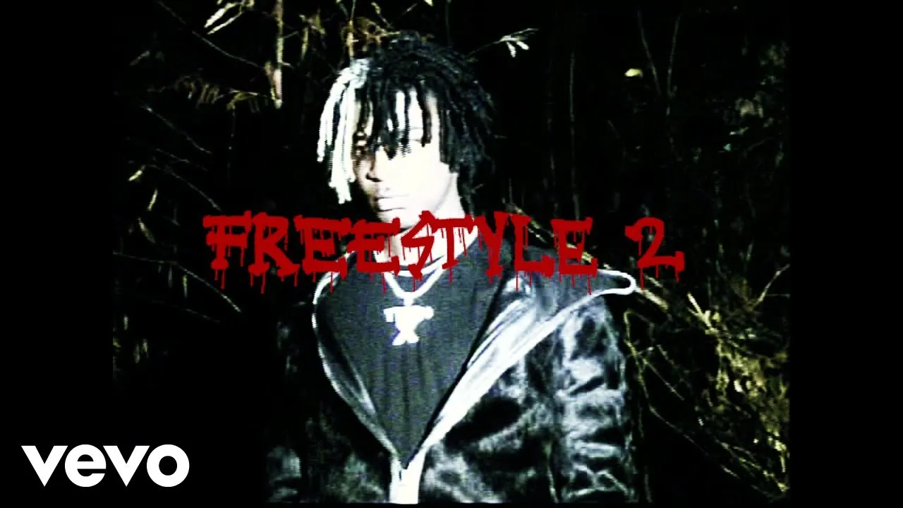 Ken Carson in a leather jacket beneath red Freestyle 2 lettering, in a black-and-white image