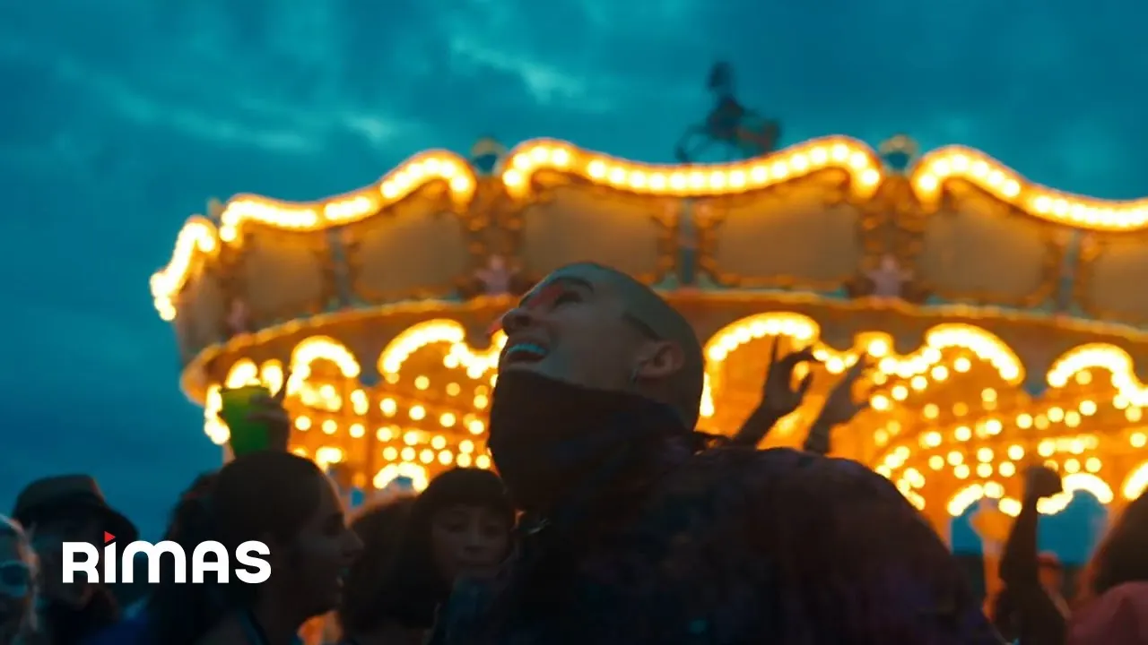 Bad Bunny in front of a brightly lit carousel at night